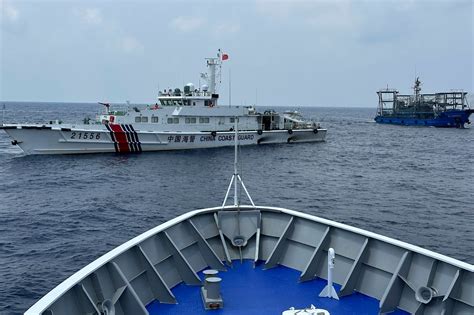 China’s forces shadow a Philippine navy ship near disputed shoal, sparking new exchange of warnings